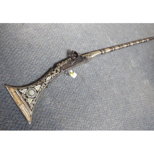 528 - A 19TH CENTURY EASTERN FLINTLOCK RIFLE, with bone inlay and white metal decoration, having metal ram... 