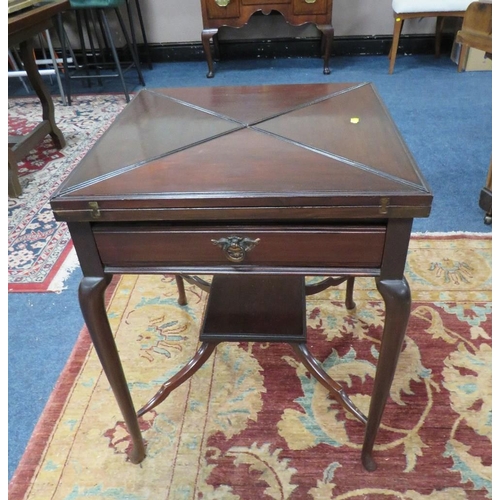 611 - AN EDWARDIAN MAHOGANY ENVELOPE GAMES TABLE, the leaves opening to a baize lined interior, with singl... 