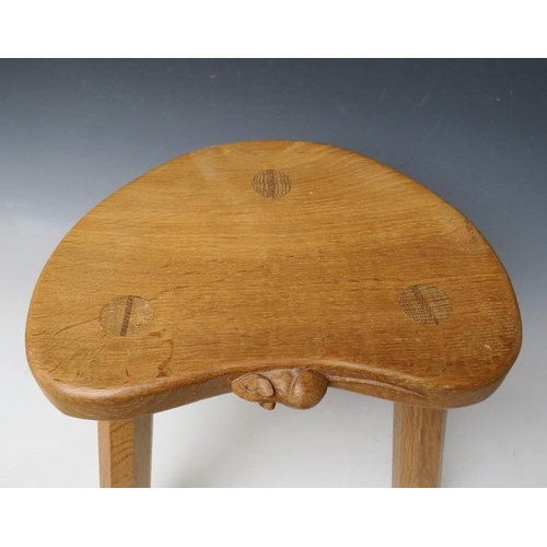 615 - A ROBERT MOUSEMAN THOMPSON THREE LEGGED STOOL, with typical carved mouse to front lip, H 36 cm