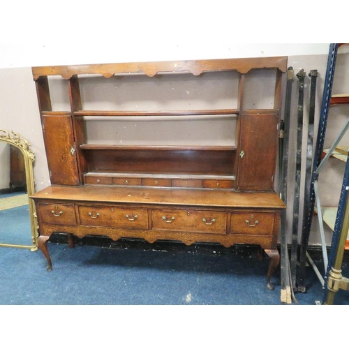 616 - A 19TH CENTURY OAK DRESSER, the open plate rack with two cupboards and five spice drawers, the lower... 