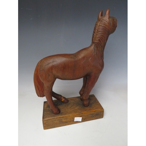 510 - AN EARLY 20TH CENTURY NAIVE WOODEN CARVING OF A HORSE, on a rectangular wooden plinth, Overall H 33 ... 