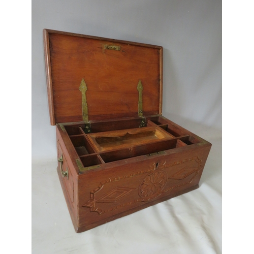 522 - AN ANTIQUE CARVED ZANZIBAR DOWRY CHEST, with twin handles, the hinged lid opening to a fitted interi... 