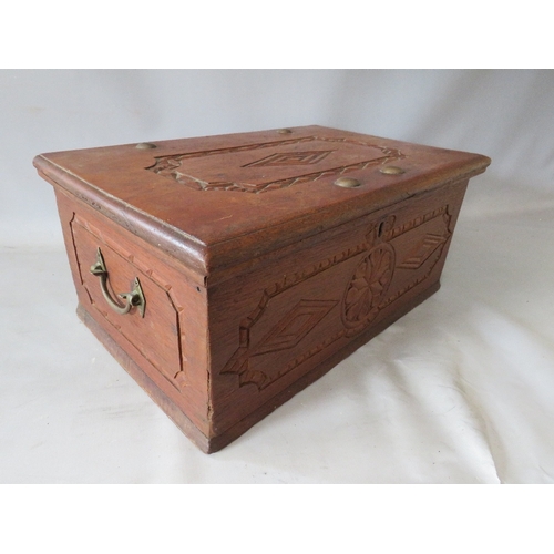 522 - AN ANTIQUE CARVED ZANZIBAR DOWRY CHEST, with twin handles, the hinged lid opening to a fitted interi... 