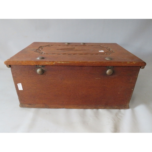 522 - AN ANTIQUE CARVED ZANZIBAR DOWRY CHEST, with twin handles, the hinged lid opening to a fitted interi... 