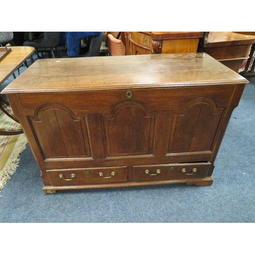 607 - AN OAK MULE CHEST, the hinged lid above a fielded triple panel front with two drawers below, raised ... 