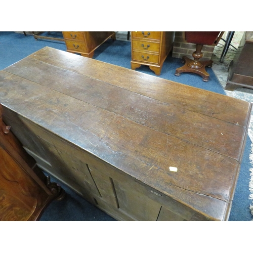 607 - AN OAK MULE CHEST, the hinged lid above a fielded triple panel front with two drawers below, raised ... 