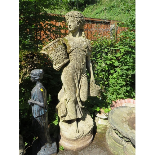 617 - A LARGE 20TH CENTURY STONE FEMALE GARDEN STATUE, with an urn in one hand and a basket of fruit in th... 