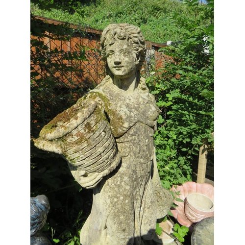 617 - A LARGE 20TH CENTURY STONE FEMALE GARDEN STATUE, with an urn in one hand and a basket of fruit in th... 