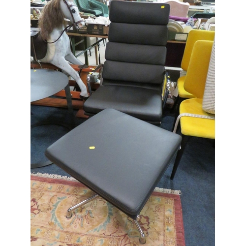 652 - A MODERN BLACK SWIVEL ARMCHAIR WITH MATCHING FOOTSTOOL (2)