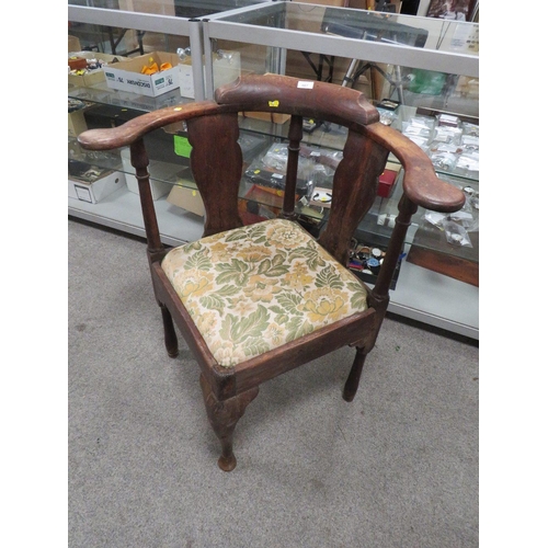 667 - AN ANTIQUE CORNER ARMCHAIR