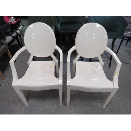 673 - A PAIR OF MODERN 'GHOST' STYLE PLASTIC ARMCHAIRS