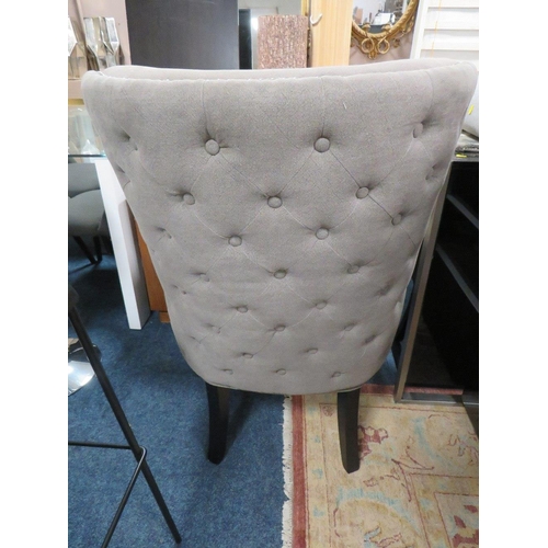 702 - A MODERN UPHOLSTERED GREY SHAPED ARMCHAIR