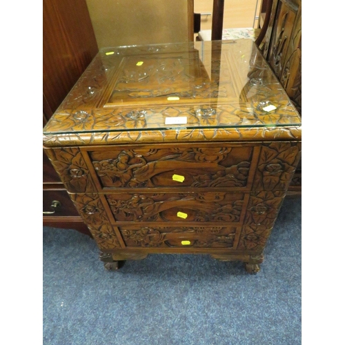 711 - A SMALL CARVED EASTERN THREE DRAWER CABINET WITH GLASS TOP H-56 W-49 CM