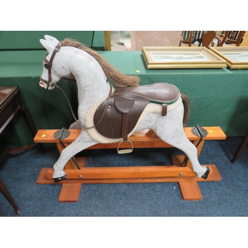 651 - AN EARLY 20TH CENTURY 'NORMAN WOOD' ROCKING HORSE ON PINE TRESTLE BASE, bearing label to neck, overa... 