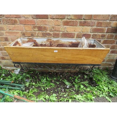 556 - A VINTAGE WOODEN TROUGH ON WROUGHT IRON BASE