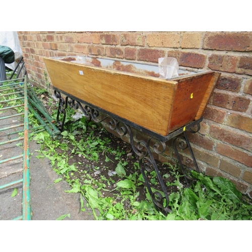 556 - A VINTAGE WOODEN TROUGH ON WROUGHT IRON BASE