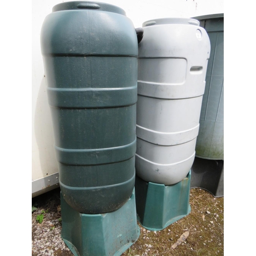 565 - THREE PLASTIC GARDEN WATER BUTTS ON STANDS