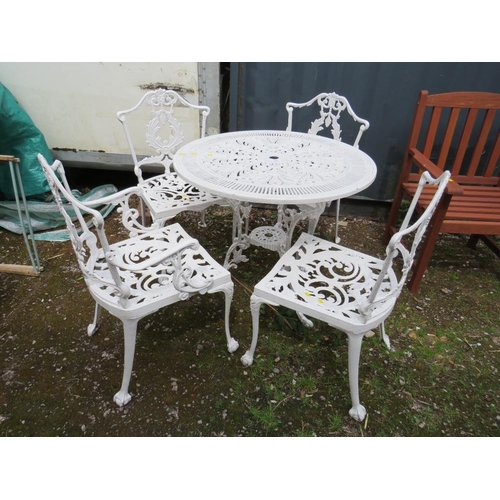 569 - A WHITE PAINTED CAST ALLOY PATIO TABLE AND FOUR CHAIRS