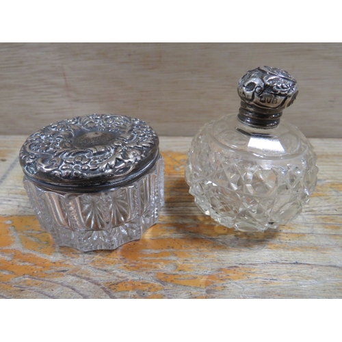 174 - TWO SILVER TOPPED VANITY JARS