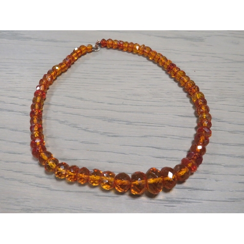 209 - AN ART DECO FACETED AMBER BEAD NECKLACE