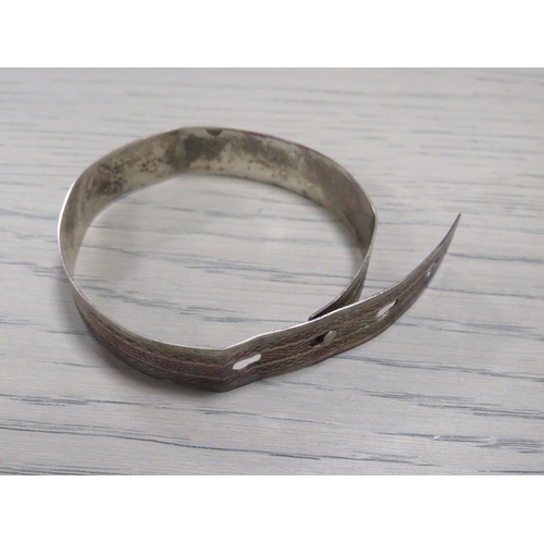 217 - A STERLING SILVER BELT TYPE BANGLE TOGETHER WITH A VINTAGE ENAMEL BROOCH