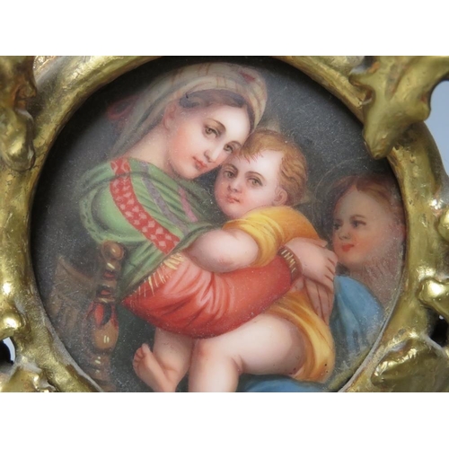 107 - AFTER RAPHAEL - A 19TH CENTURY CONTINENTAL CIRCULAR PORCELAIN PLAQUE OF THE MADONNA & CHILD, unsigne... 