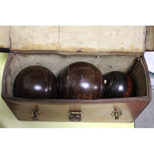 240 - AN ANTIQUE LEATHER CASED SET OF WOODEN TURNED LAWN BOWLS COMPLETE WITH JACK BY THOMAS TAYLOR OF GLAS... 