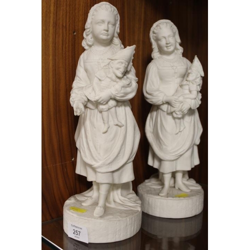 257 - A PAIR OF VINTAGE PARIAN WARE STYLE FIGURINES OF YOUNG GIRLS HOLDING MR PUNCH PUPPETS