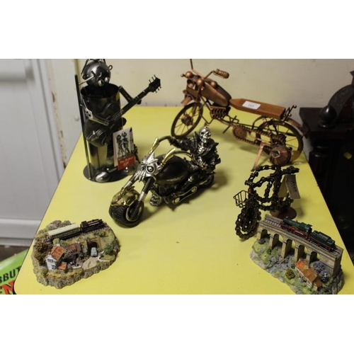 265 - A COLLECTION OF NOVELTY MOTORBIKES FIGURES ETC