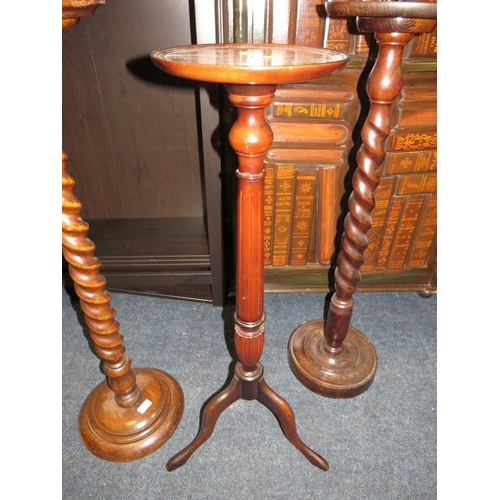 888 - TWO VINTAGE OAK BARLEYTWIST TORCHERES PLUS A MAHOGANY EXAMPLE (3)