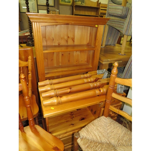 915 - A HONEY PINE BOOKCASE, HEADBOARD, TABLE AND FOUR CHAIRS PLUS A MEDIA CABINET