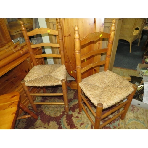 915 - A HONEY PINE BOOKCASE, HEADBOARD, TABLE AND FOUR CHAIRS PLUS A MEDIA CABINET