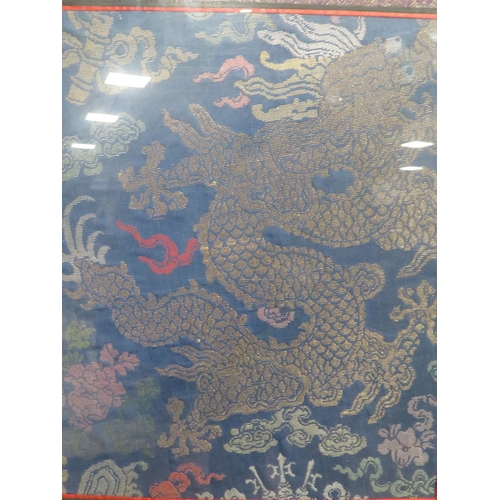 16 - A FRAMED AND GLAZED CHINESE SILKWORK PANEL OF A FIVE TOED DRAGON