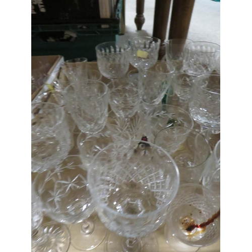 153 - TWO TRAYS OF GLASSWARE TO INCLUDE DRINKING GLASSES , CANDLESTICKS ETC