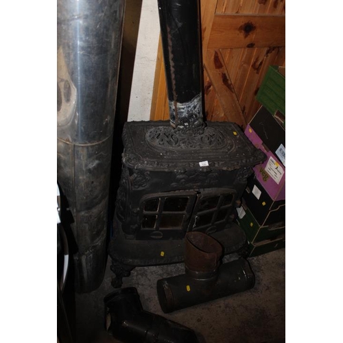 720 - A CAST IRON LOG BURNER WITH CHIMNEY