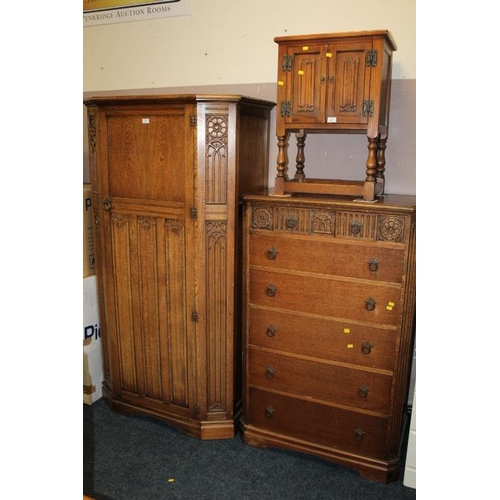 842 - AN OAK LINENFOLD GENTS WARDROBE & A SIX DRAWER CHEST (2)