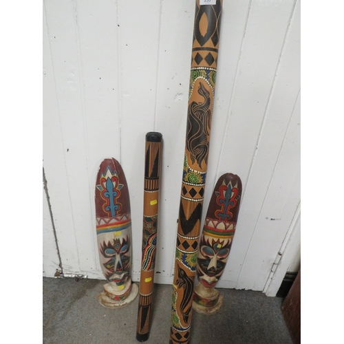 253 - TWO ABORIGINAL STYLE DIGERIDOOS TOGETHER WITH TWO TRIBAL WALL MASKS