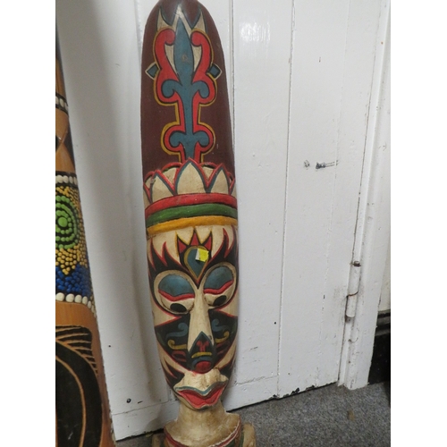 253 - TWO ABORIGINAL STYLE DIGERIDOOS TOGETHER WITH TWO TRIBAL WALL MASKS