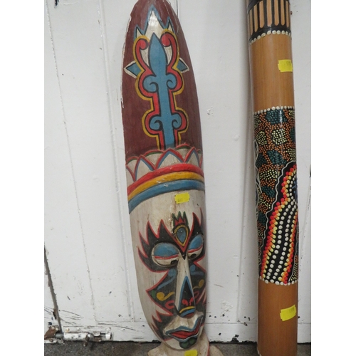 253 - TWO ABORIGINAL STYLE DIGERIDOOS TOGETHER WITH TWO TRIBAL WALL MASKS