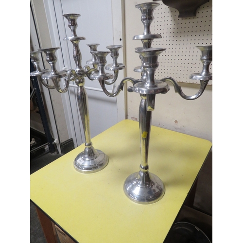 255 - A PAIR OF POLISHED METAL CANDELABRA