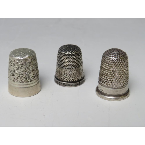 238 - A CHARLES HORNER WHITE METAL THIMBLE, together with a Charles Horner hallmarked silver thimble and a... 