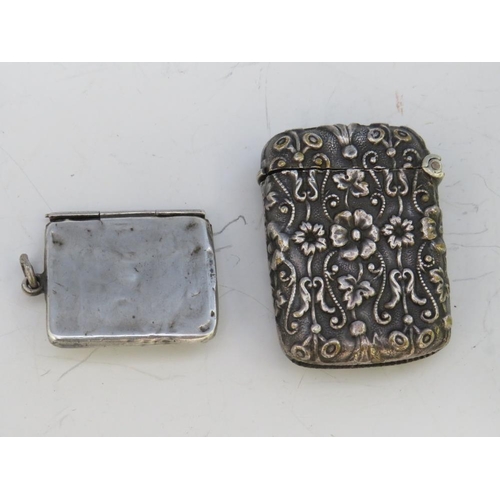 239 - A VINTAGE ORNATE WHITE METAL VESTA CASE, together with a hallmarked silver envelope stamp case, 2 x ... 