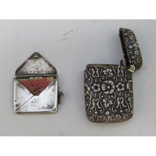 239 - A VINTAGE ORNATE WHITE METAL VESTA CASE, together with a hallmarked silver envelope stamp case, 2 x ... 