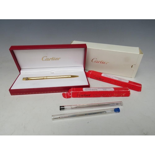 242 - A BOXED CARTIER 'TRINITY' STYLE GOLD PLATED BALLPOINT PEN, together with two refills (unchecked)