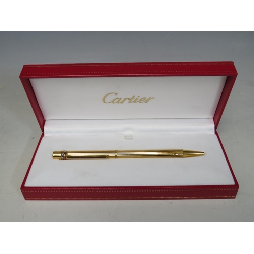 242 - A BOXED CARTIER 'TRINITY' STYLE GOLD PLATED BALLPOINT PEN, together with two refills (unchecked)