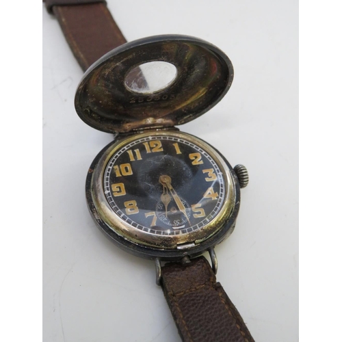 352 - A WW1 SILVER CASED HALF HUNTER TRENCH WRISTWATCH, with leather strap, visible dial Dia. .75 cm, case... 