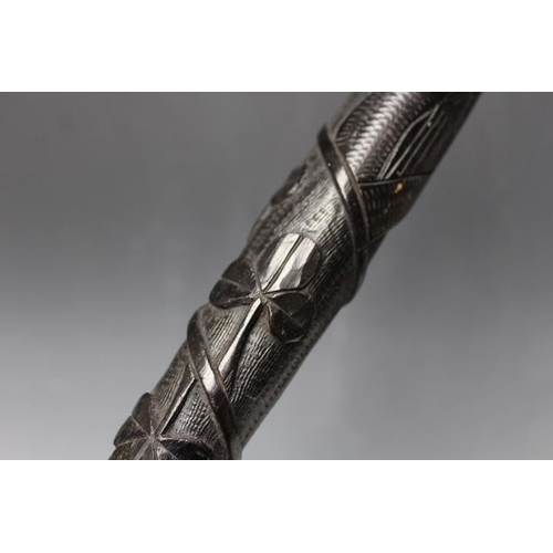 803 - A VINTAGE IRISH CARVED BOG OAK TRUNCHEON, decorated with shamrocks, L 30 cm