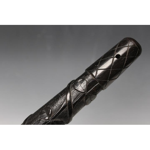 803 - A VINTAGE IRISH CARVED BOG OAK TRUNCHEON, decorated with shamrocks, L 30 cm