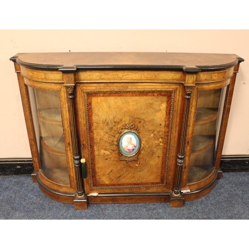 951 - A VICTORIAN WALNUT CROSSBANDED CREDENZA, the single panelled door with a continental oval porcelain ... 