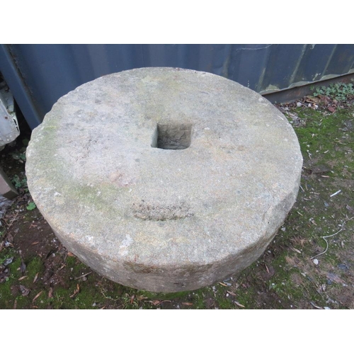 955 - AN ANTIQUE SANDSTONE MILL STONE ON STAND, H 73 cm